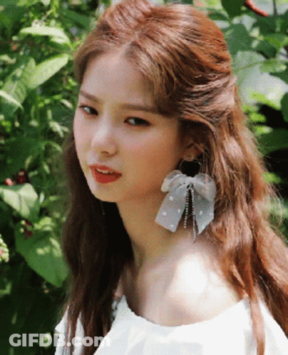 Girl Wearing White Off Shoulder Top And Earrings GIF