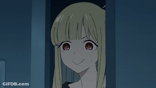Girl With Blonde Hair And Black Shirt Smiling In Dark Room GIF