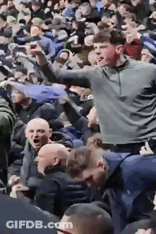 Girl With Blonde Hair And Green Eyes Looks At Man GIF