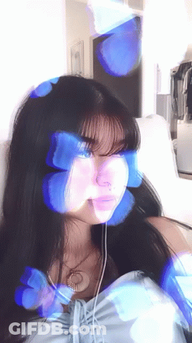 Girl With Blue Butterflies On Face Sitting On Couch GIF