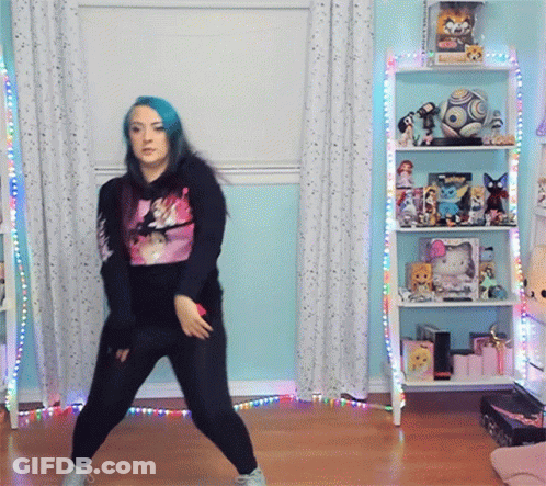 Girl With Blue Hair Dancing In Front Of Shelf With Soccer Ball GIF