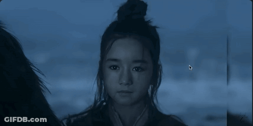 Girl With Bun Looking At Camera GIF