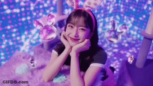 Girl With Bunny Ears Laying On Purple Blanket GIF