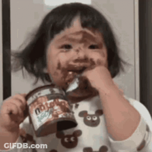 Girl With Chocolate Face Holding Nutella GIF