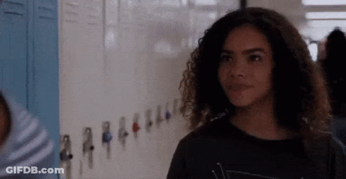 Girl With Curly Hair By School Lockers GIF
