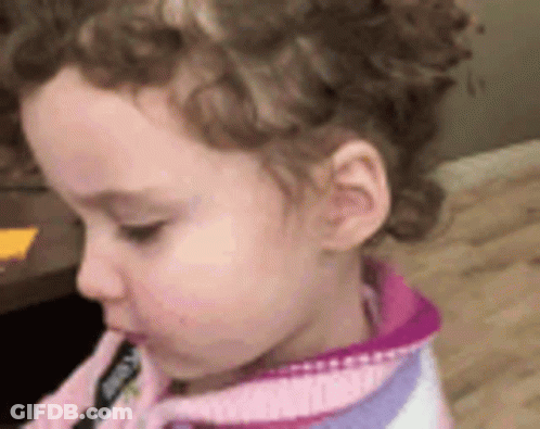 Girl With Curly Hair In Pink And Purple Sweater GIF
