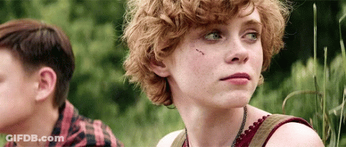 Girl With Curly Hair Next To Boy In Plaid Shirt GIF