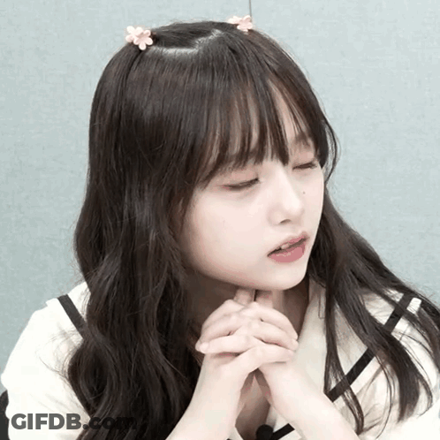 Girl With Flower In Hair And Eyes Closed GIF