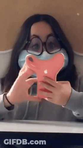 Girl With Glasses And Mask Holding Apple Phone GIF