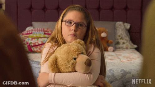 Girl With Glasses Hugging Teddy Bear Netflix Logo GIF