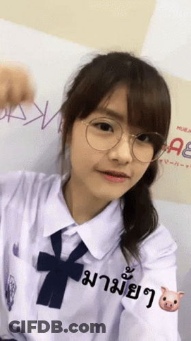 Girl With Glasses In Front Of AE Sign GIF