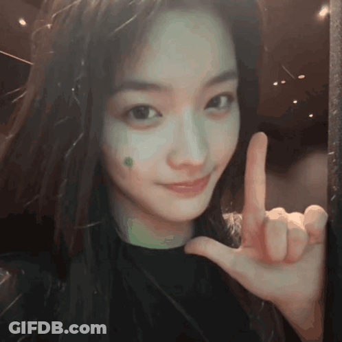 Girl With Green Spot Peace Sign GIF