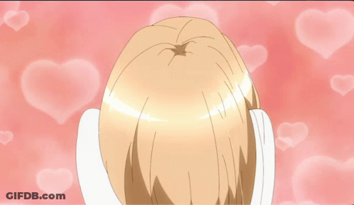 Girl With Hands On Face Surrounded By Pink Hearts GIF