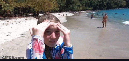 Girl With Hands On Head On Beach GIF