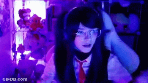 Girl With Headphones And Glasses At Computer In Dark Room GIF