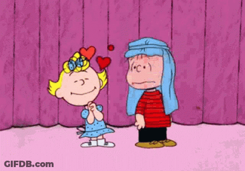 Girl With Heart On Head Next To Boy Covering Face With Pillow GIF