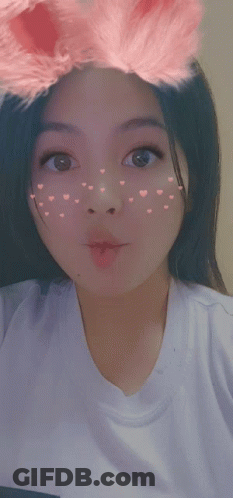 Girl With Hearts On Face In White T-Shirt GIF