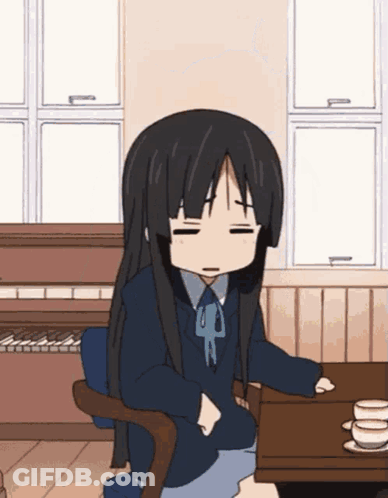 Girl With Long Black Hair Sitting With Eyes Closed GIF