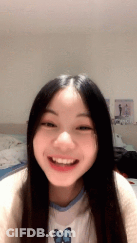 Girl With Long Black Hair Smiling In Butterfly Shirt GIF