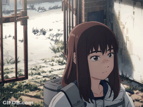 Girl With Long Brown Hair Standing In Front Of Gate GIF