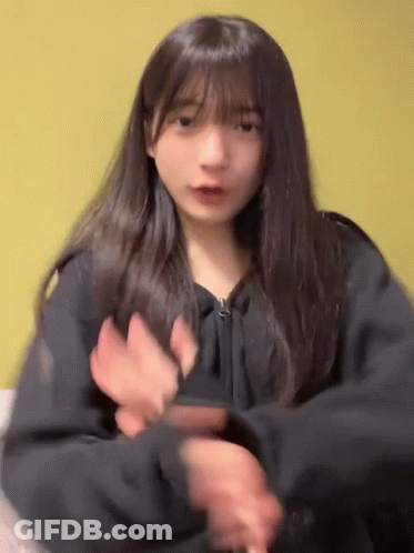 Girl With Long Hair And Bangs Dancing In Black Jacket GIF