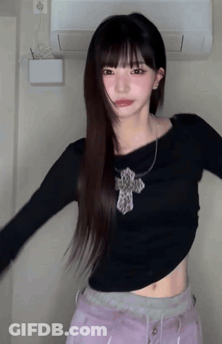 Girl With Long Hair In Black Crop Top With Cross GIF