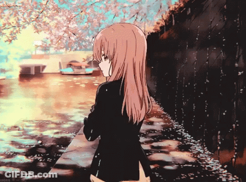 Girl With Long Hair Standing Near Water With Flowers GIF
