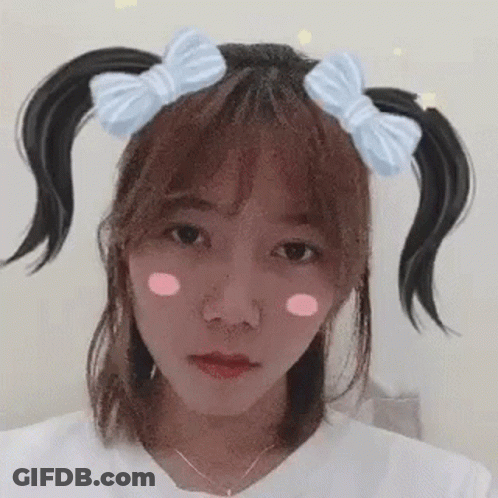 Girl With Pigtails And Bow Making Funny Face GIF