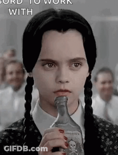 Girl With Pigtails Holding Liquor Bottle In Mouth GIF