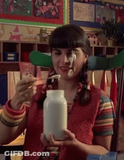 Girl With Pigtails Holding Milk Jar GIF