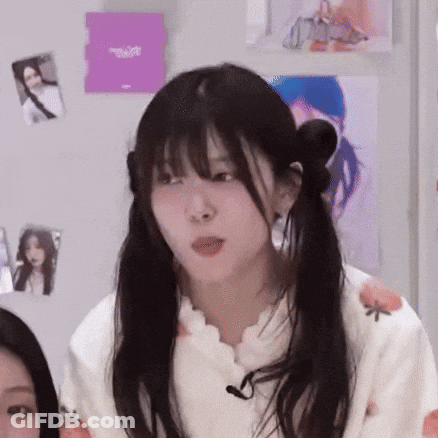 Girl With Pigtails Sitting With Microphone GIF