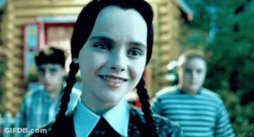 Girl With Pigtails Smiling In Front Of Children GIF