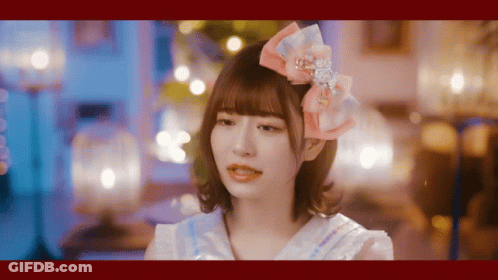 Girl With Pink Bow Looking At Camera GIF