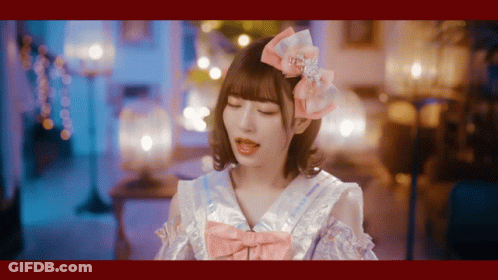 Girl With Pink Bow Looking At Camera GIF