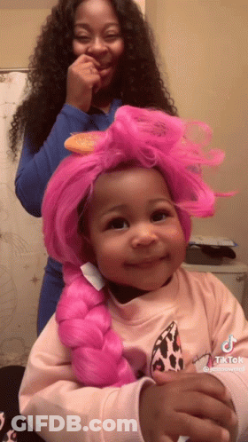 Girl With Pink Braided Wig Being Brushed GIF