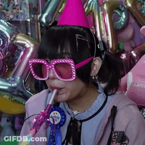 Girl With Pink Glasses And Party Hat Blowing Horn GIF
