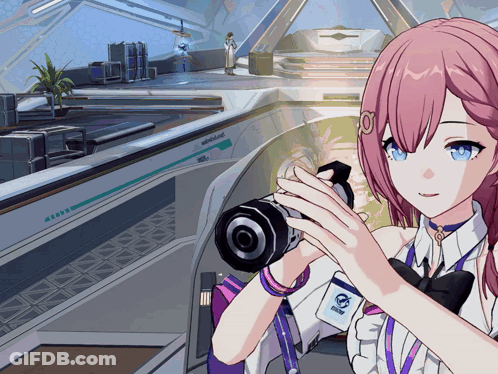 Girl With Pink Hair Holding Camera And Name Tag Saying A GIF