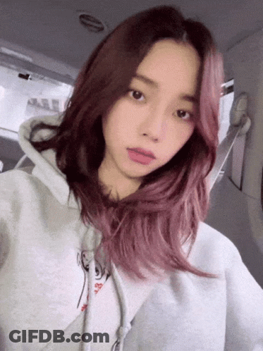 Girl With Pink Hair In Grey Hoodie Taking Selfie GIF