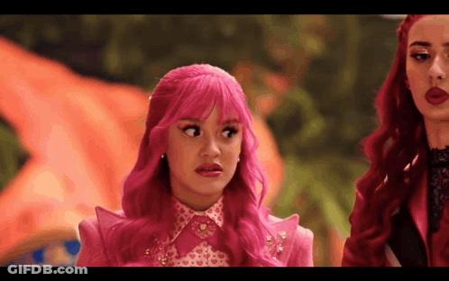 Girl With Pink Hair Making Funny Face Next To Redhead GIF
