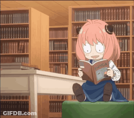 Girl With Pink Hair Reading Manga In Library GIF