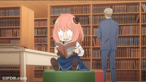 Girl With Pink Hair Reading Manga In Library GIF
