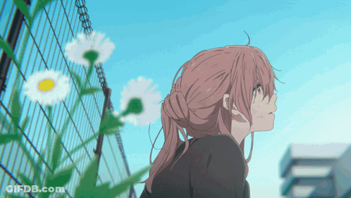 Girl With Pink Hair Standing In Front Of Fence With Daisies GIF