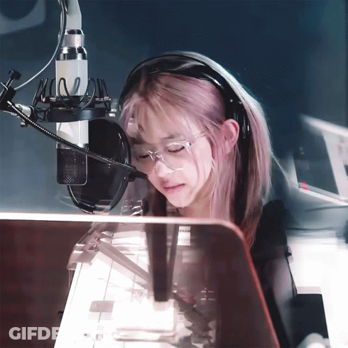 Girl With Pink Hair Wearing Headphones And Glasses At Microphone GIF