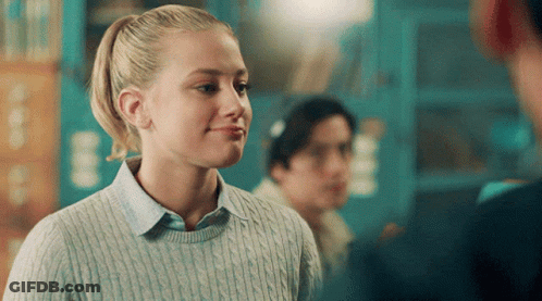 Girl With Ponytail In Blue Sweater Smiling GIF