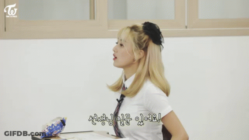 Girl With Ponytail In Classroom With Korean Writing GIF
