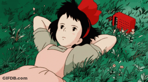 Girl With Red Bow Laying In Grass GIF