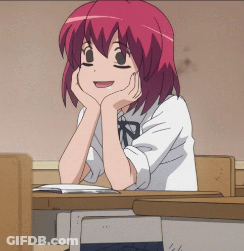 Girl With Red Hair Hands On Chin At Desk GIF