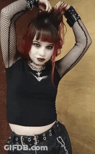 Girl With Red Hair In Black Top And Belt GIF