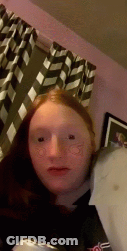 Girl With Red Hair Sitting By Window GIF