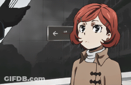 Girl With Red Hair Standing In Front Of Sign Pointing Left GIF